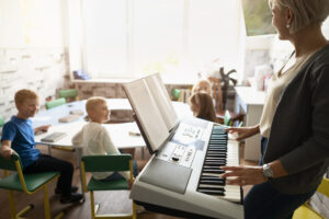 side-view-teacher-playing-piano